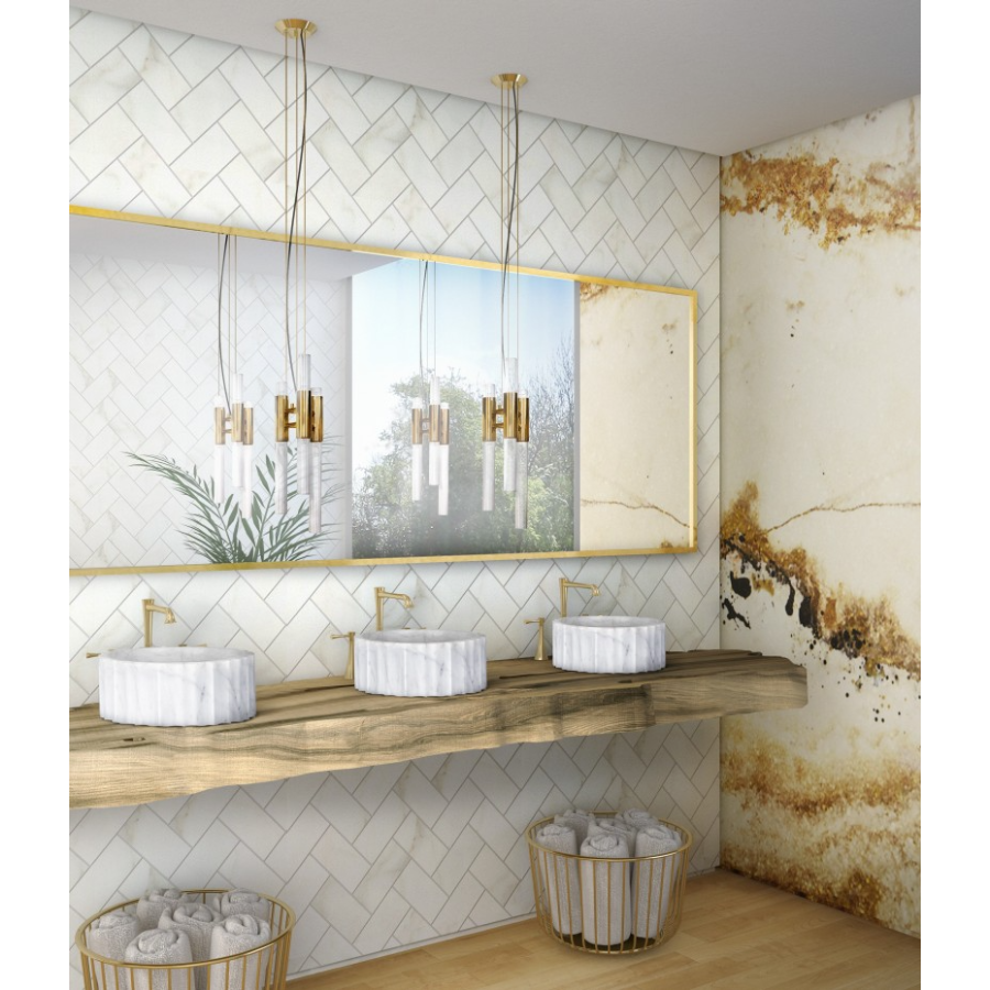 BRIGHT HOTEL BATHROOM WITH SYMPHONY VESSEL SINK AND GOLD ONYX SURFACE