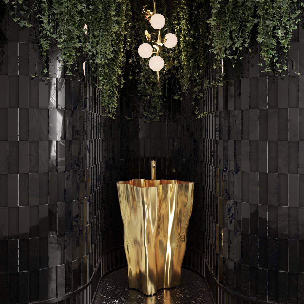 Luxury powder bathroom featuring the gold Eden Pedestal Sink, glossy black tiles, Hera Pendant Lamp, cascading greenery, and terrazzo flooring for a modern, nature-inspired design.