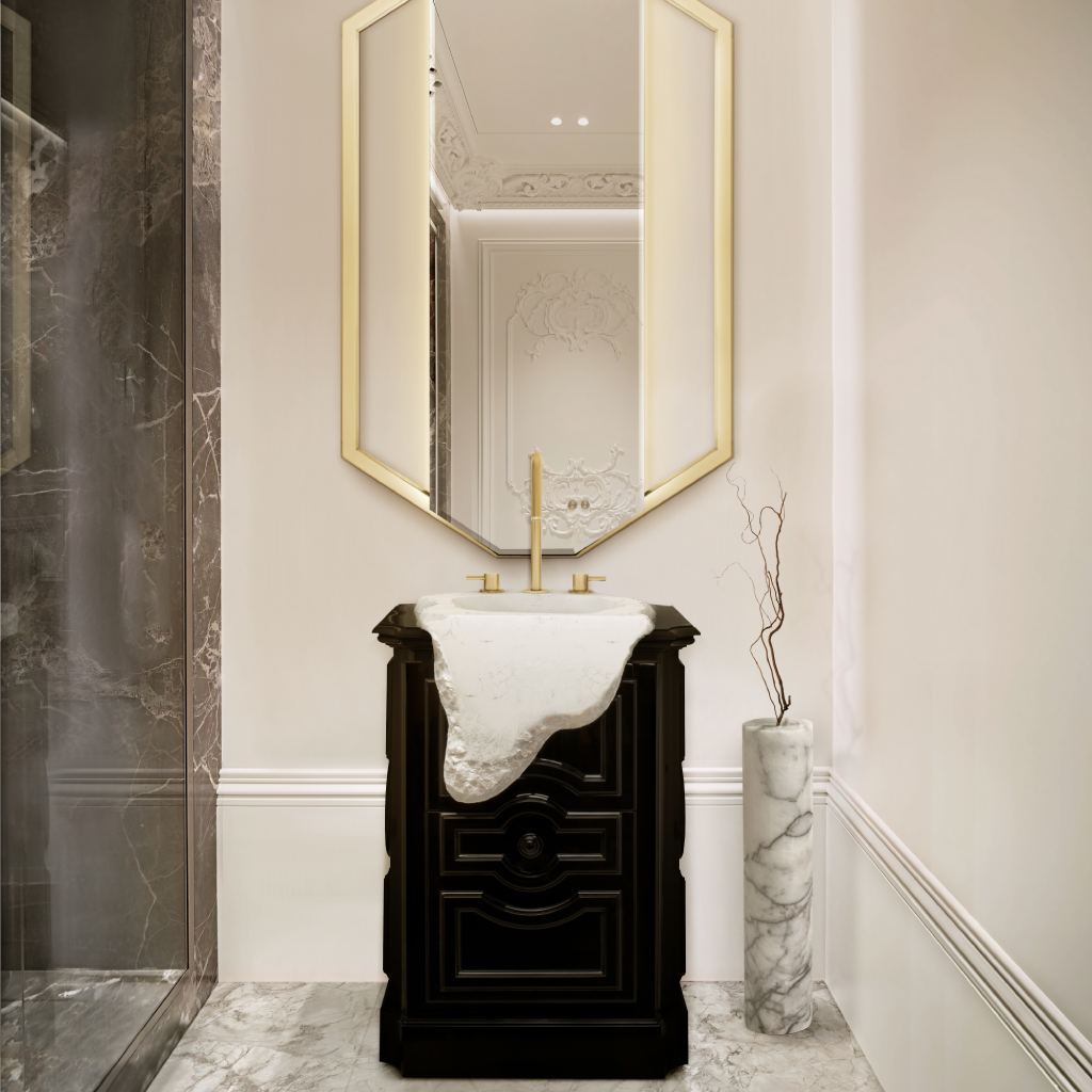 Contemporary luxury powder bathroom with Petra Pedestal Sink, gold Pulse Three Hole Mixer Tap, Sapphire Mirror in a gold octagonal frame, marble flooring, and minimalist marble vase.
