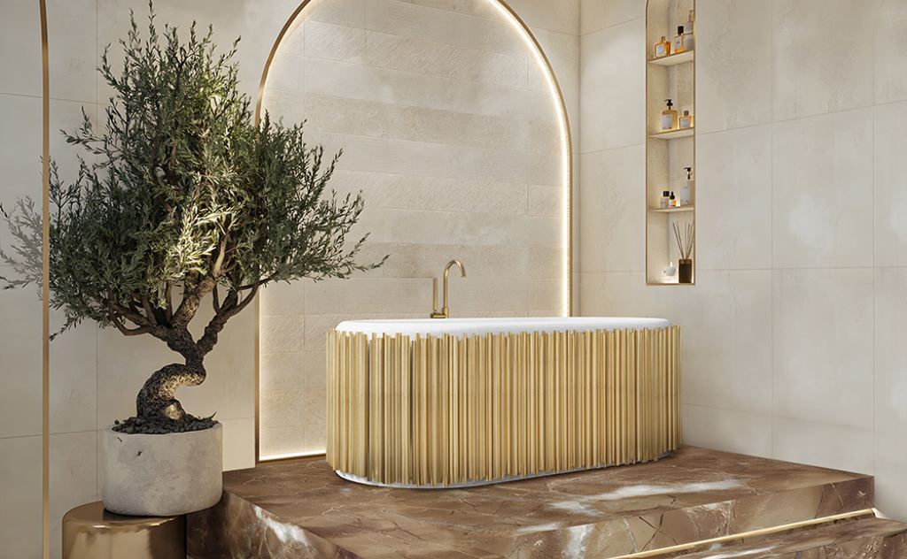 Spa-inspired master bathroom with Symphony Oval Bathtub in golden metallic finish, Pulse Floor Mixer with Hand Shower, marble platform, LED-lit niche, and sculptural bonsai tree.